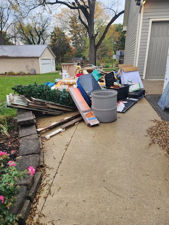 Dumpster being loaded with debris for Roofing Dumpster Rental in Jerome